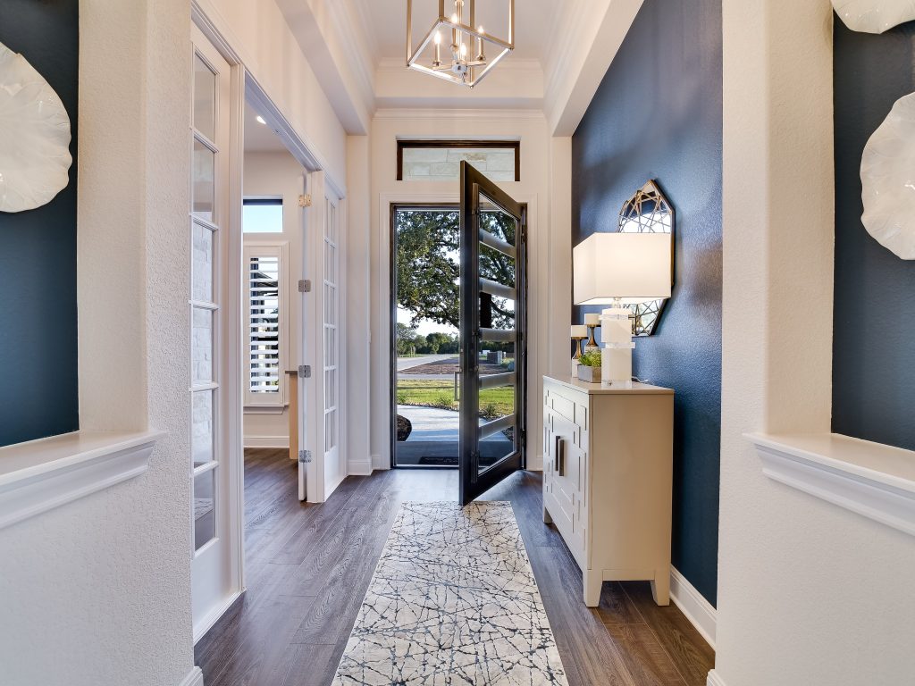 Giddens Homes Entryway with solid wood flooring and modern wall decorations