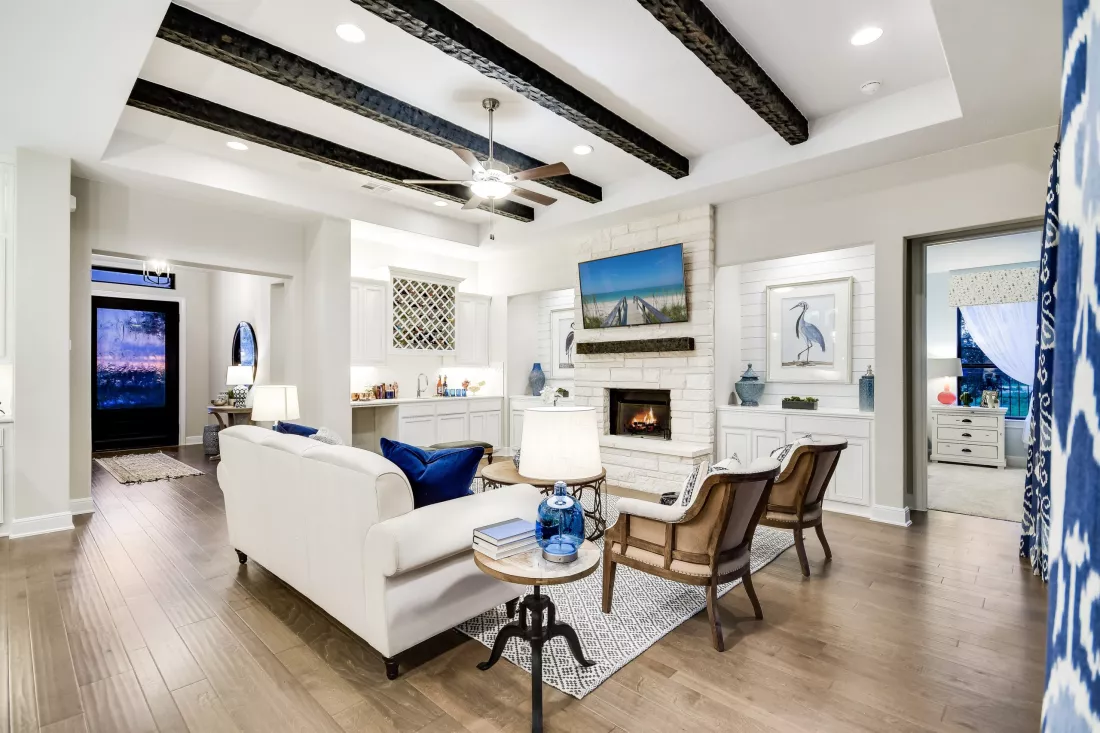 View of living room area in Riverstone model home with high ceiling and ample natural light